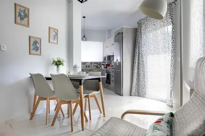 a kitchen and dining room with a table and chairs at E&G Relax Homes-E in Kissamos