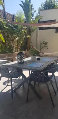 a picnic table and two chairs on a patio at E&G Relax Homes-E in Kissamos