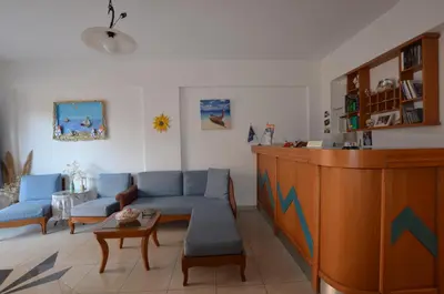 a living room with a couch and a table at Kochyli Studios in Palaiochóra