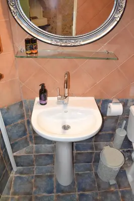 a bathroom with a sink and a mirror at Yro Studios in Chania Town