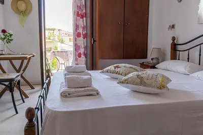 a bedroom with two beds with towels on them at Poseidon Studios Chania Center in Chania Town