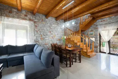 a living room with a blue couch and a table at Charming Villa in Gerani Chanion