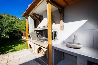 an outdoor kitchen with a stone sink on a counter at Charming Villa in Gerani Chanion