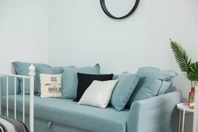 a blue couch with pillows in a living room at Anastasia’s House in Kissamos