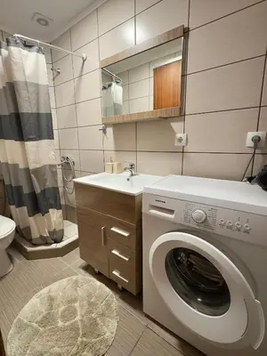 a bathroom with a washing machine and a sink at Anastasia’s House in Kissamos