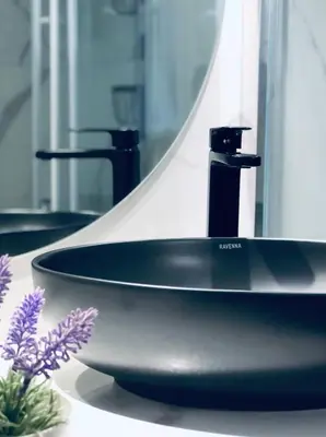 a black sink in a bathroom with a mirror at Rafaellas Apartment in Chania Town