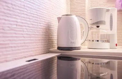 a counter with two appliances sitting on a shelf at Rafaellas Apartment in Chania Town