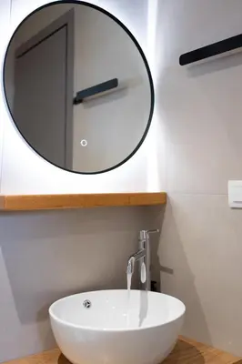 a bathroom with a white sink and a mirror at Romeos Studios in Agia Marina Nea Kydonias