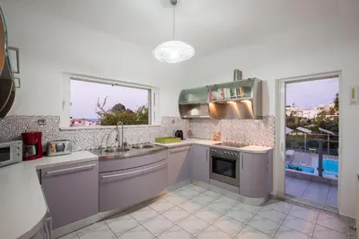a kitchen with a sink and a stove at Villa Asteri in Kalamaki Chanion