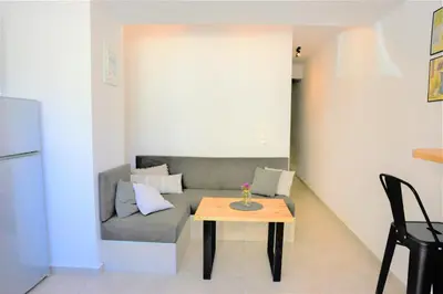 a living room with a couch and a table at Iconic Chania in Chania Town