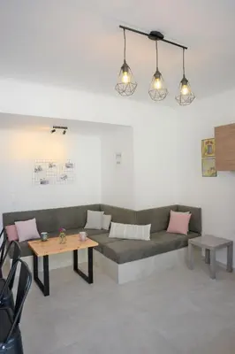 a living room with a couch and a table at Iconic Chania in Chania Town