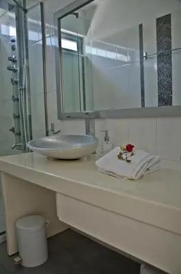 a bathroom counter with a sink and a mirror at Reveli Estate in Kalathas