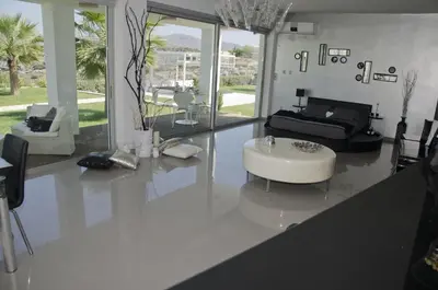 a white living room with a table and a couch at Reveli Estate in Kalathas
