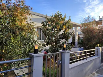 a house with a fence with a tree on it at casa Marilia in Chania Town