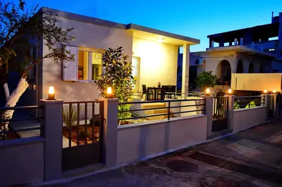a house with lights on a fence in front of it at casa Marilia in Chania Town