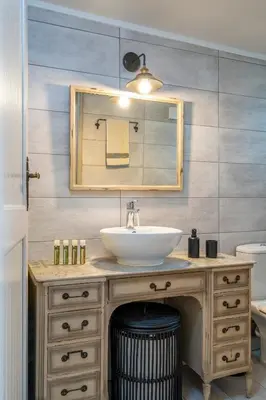 a bathroom with a sink and a mirror at Casa Chrysa Chania 1st floor house with amazing view in Galatás