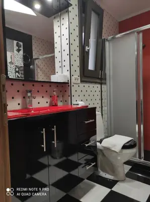 a bathroom with a black and white checkered floor at Homieland Souda in Souda