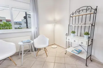 a room with a table and two chairs and a lamp at Marika's Guest House Chania in Chania Town