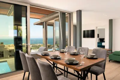 a dining room with a table and chairs at NV Illusion in Chania Town