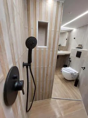a bathroom with a shower with a toilet in it at Evans House II One Bedroom Maisonette in Chania Town
