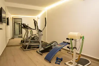 a gym with three exercise bikes in a room at NV Two in Chania Town