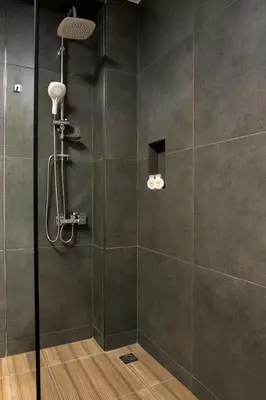 a shower with a glass door in a bathroom at NV Two in Chania Town