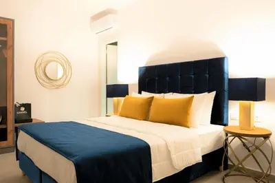 a bedroom with a large bed with a blue headboard at NV Two in Chania Town
