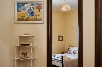 a room with a mirror next to a bed at Batilas Garden House in Kissamos