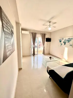 a living room with a couch and a table at Casa de Campo 1 in Almirida