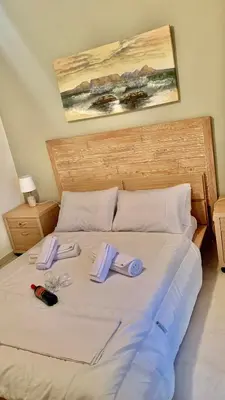a bed with towels and slippers on top of it at Casa de Campo 1 in Almirida