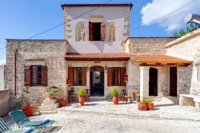a stone house with plants in front of it at Traditional Home Vereniki With Heated Pool - BY APOKORONAS VILLAS in Gavalochori