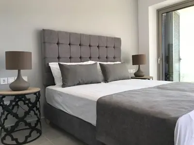 a bedroom with a large bed with two lamps at NV One in Chania Town