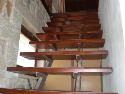 a set of wooden stairs in a building at Vasiliki's Residence - Breathtaking View in Kissamos