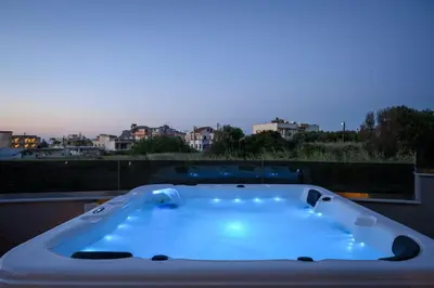 a bath tub sitting on top of a balcony at Sun Ray Beach Life Villa in Agia Marina Nea Kydonias
