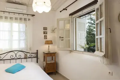a bedroom with a bed and a window at House Erofili in Chania Town