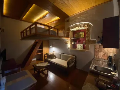 a living room with a staircase and a couch at Microcosmos Halepas in Chania Town