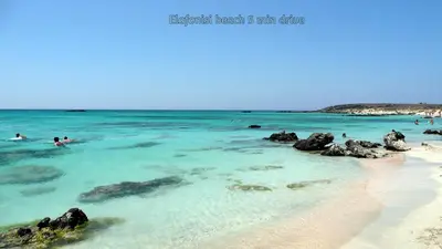 a group of people swimming in the water at the beach at Sea Lake Holiday House in Elafonisi