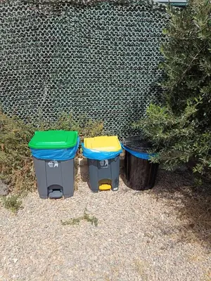 three trash cans sitting next to a fence at Sea Lake Holiday House in Elafonisi
