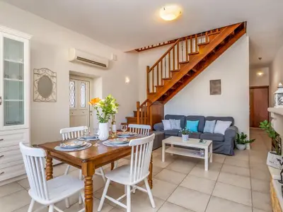 a living room with a table and chairs and a couch at Casteli Stone Residence in Kissamos