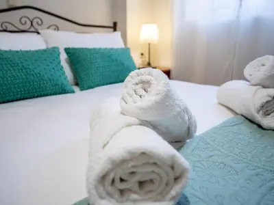 a pair of towels on a bed at Casteli Stone Residence in Kissamos