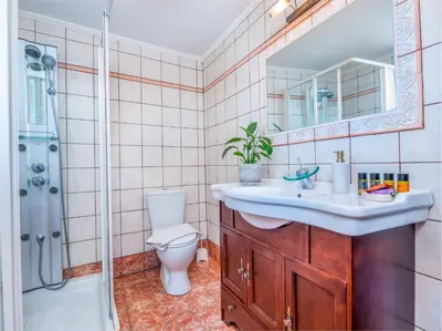 a bathroom with a sink and a toilet and a shower at Casteli Stone Residence in Kissamos