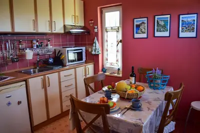 a kitchen with a table with a bowl of fruit on it at MaGea- Asterias Ground floor peaceful apartment in Tavronitis