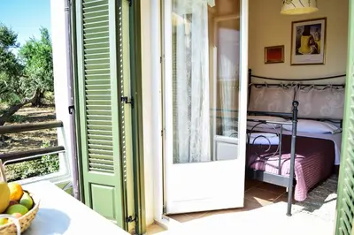 an open door to a bedroom with a bed at MaGea- Asterias Ground floor peaceful apartment in Tavronitis