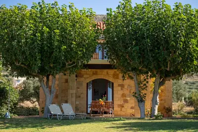 a stone house with trees in front of it at Stay in Falassarna Villas in Falasarna