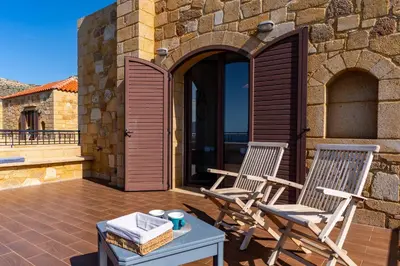 two chairs and a table on a patio at Stay in Falassarna Villas in Falasarna