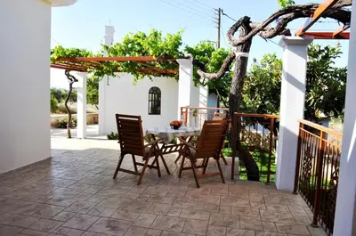 a patio with a table and chairs on a porch at Anna 's House - Garden Cottage in Kissamos in Kissamos