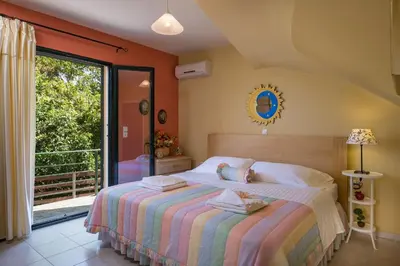 a bedroom with a bed and a balcony at Villa La Palma in Vrísai