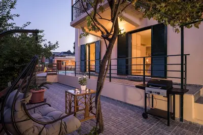a balcony of a building with a grill on it at Villa La Palma in Vrísai