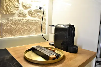 a coffee maker and a toaster on a wooden table at The Well in Chania Town