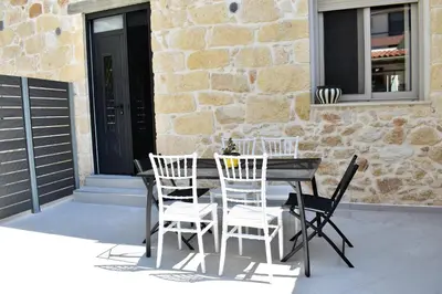 a table and chairs on a patio in front of a building at The Well in Chania Town
